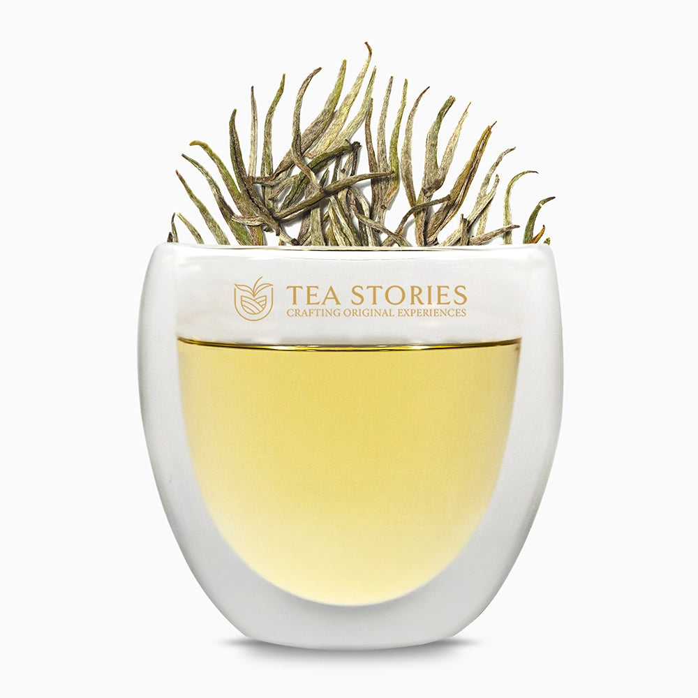 Teastories: Premium white tea leaves and brewed liquor in signature glass.