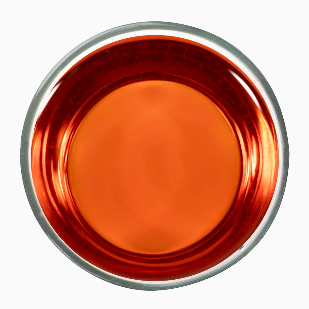 Orange tea liquid in metal bowl — iconic of Kulukkumalai’s orthodox style.