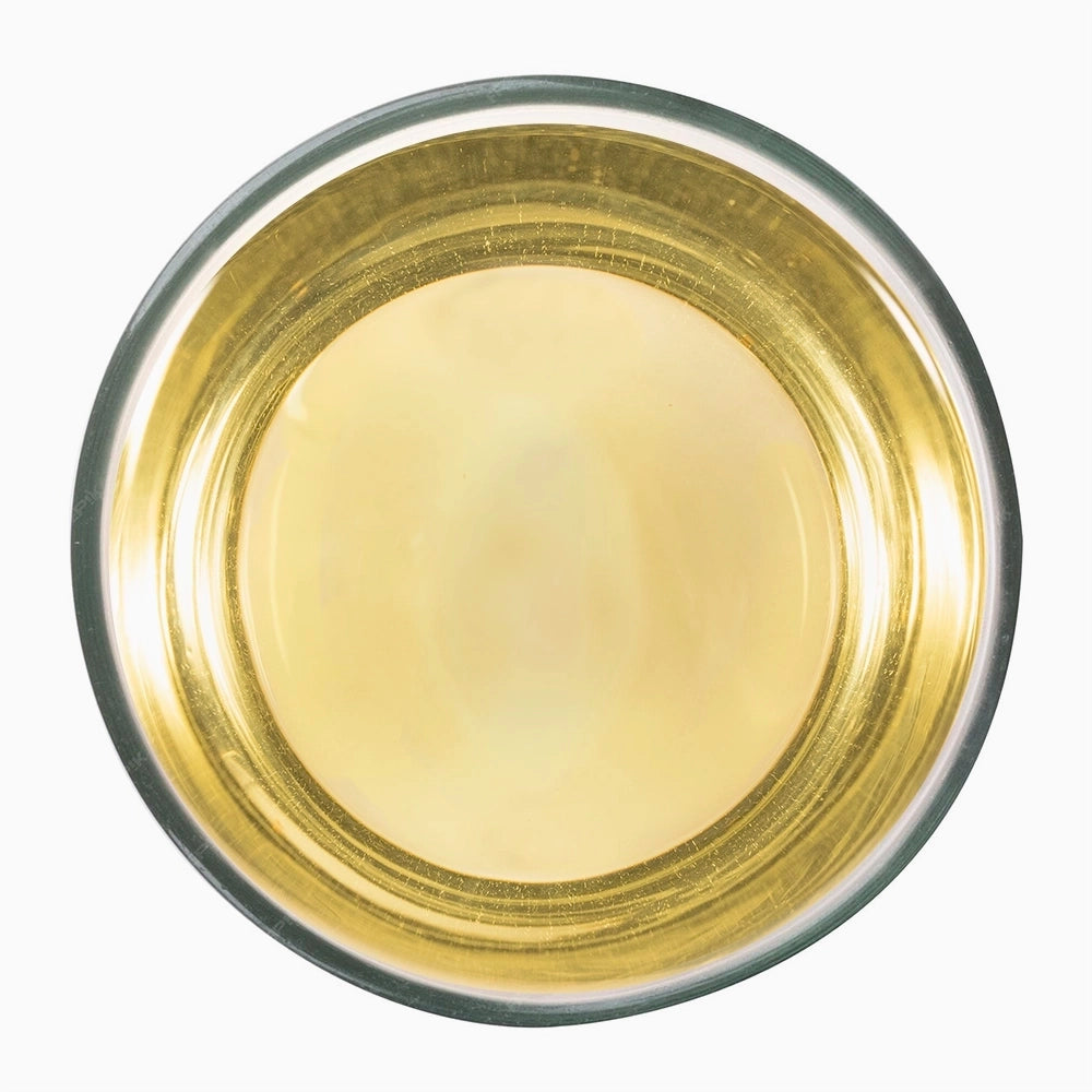 Top view of freshly brewed Teastories' The Lockhart Lux white tea, showing its pale golden liquor.