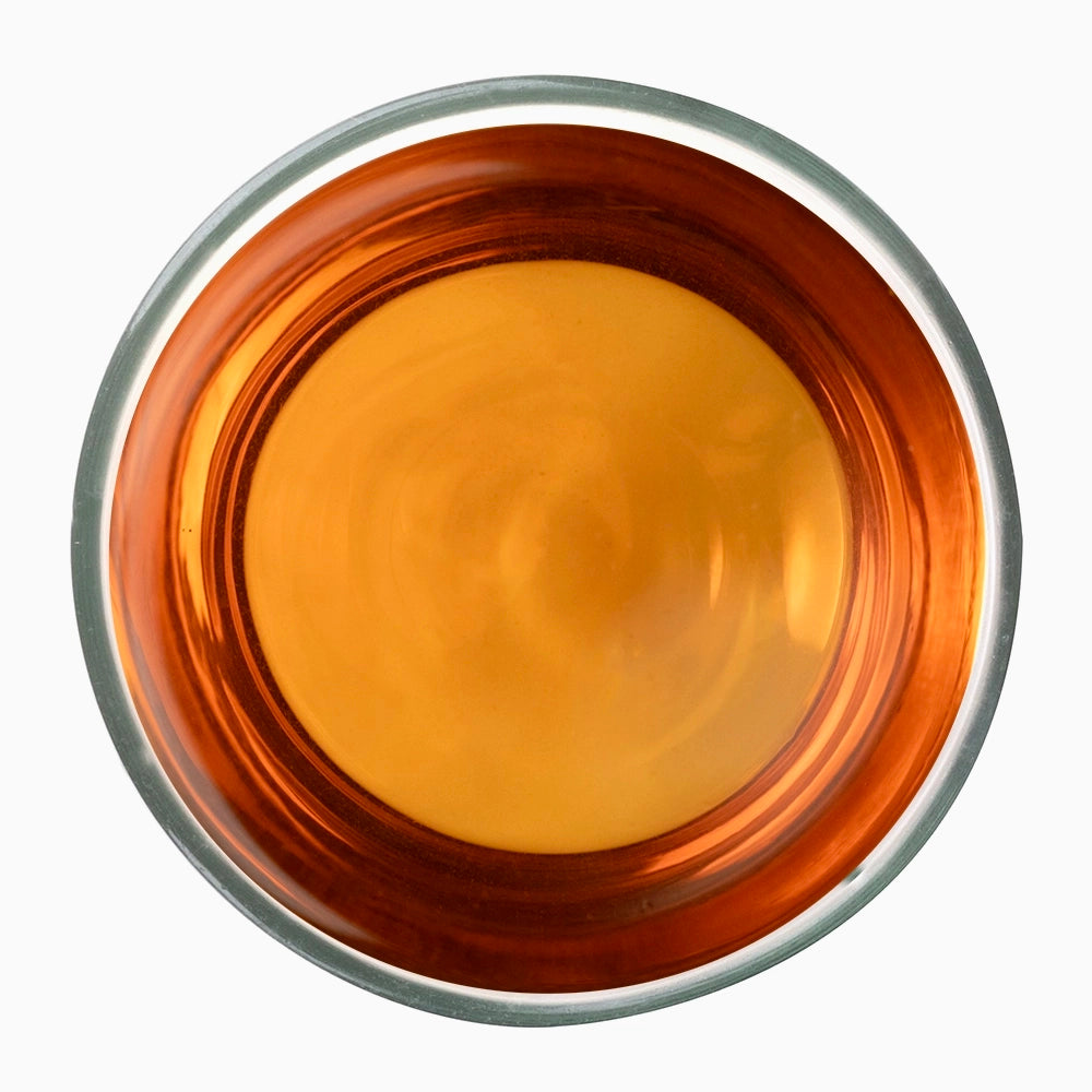 Orange tea liquid in metal bowl — iconic of Palar onyx orthodox tea style.