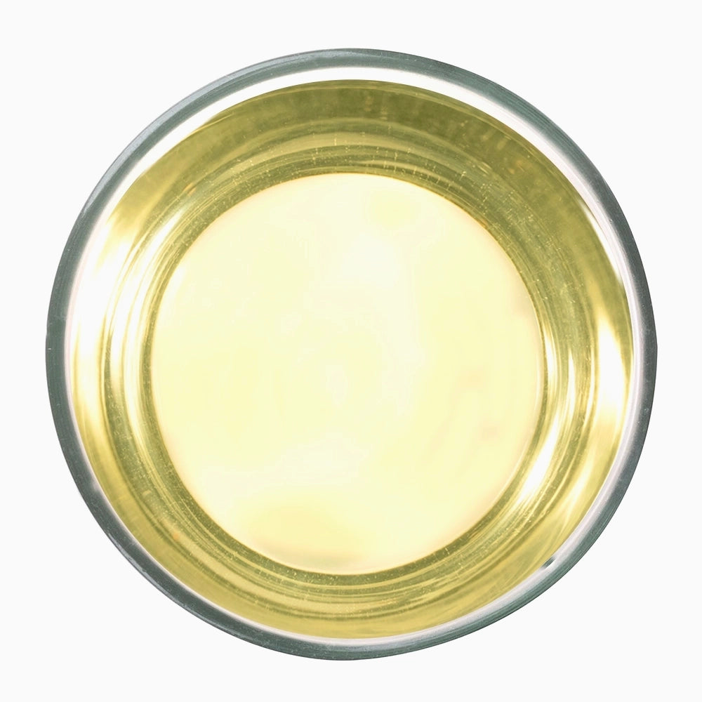 White bowl with twirl brewed cup liquid —Pattumalay Emerald premium tea visual.