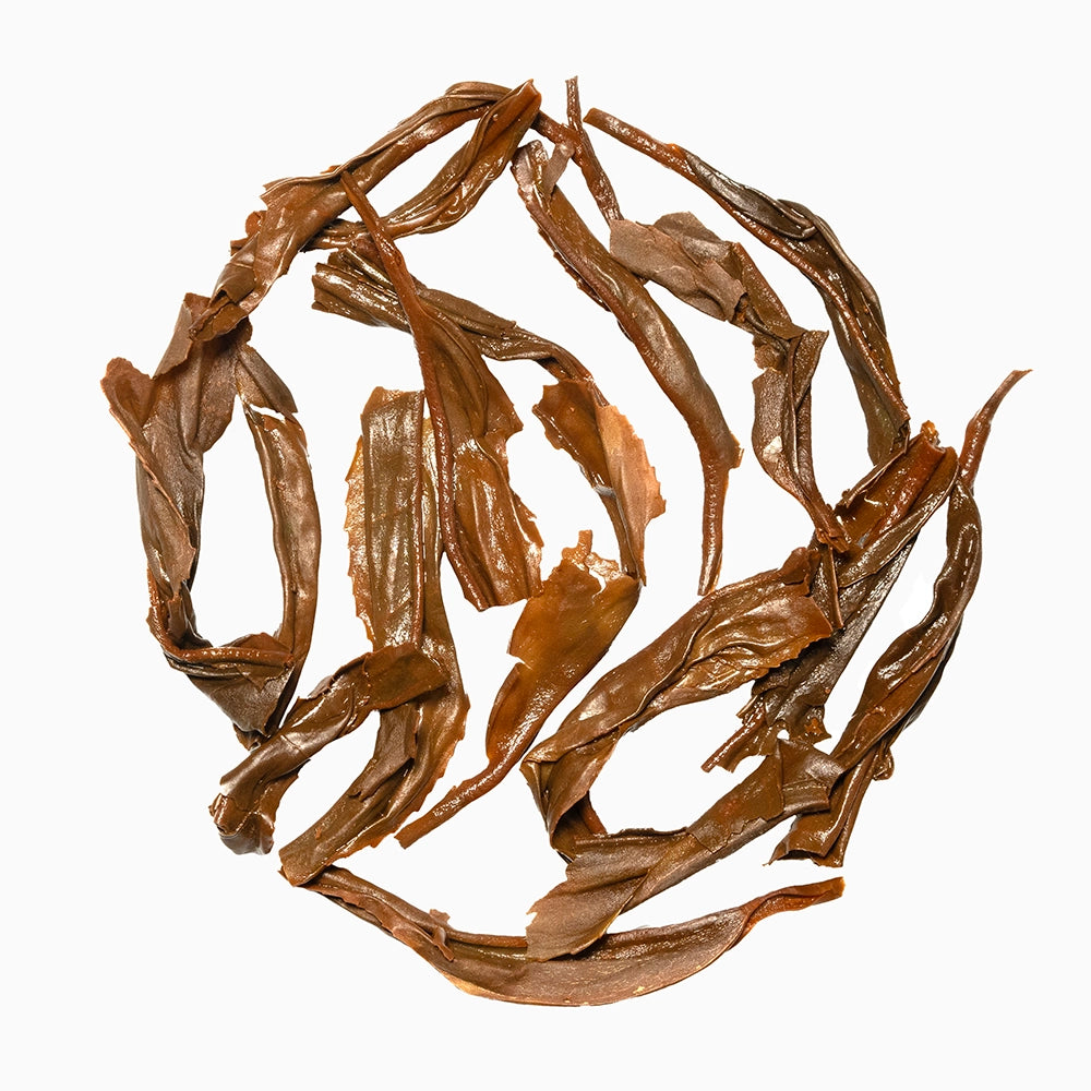 Wet, unfurled tea leaves — demonstrating infusion quality and leaf integrity.