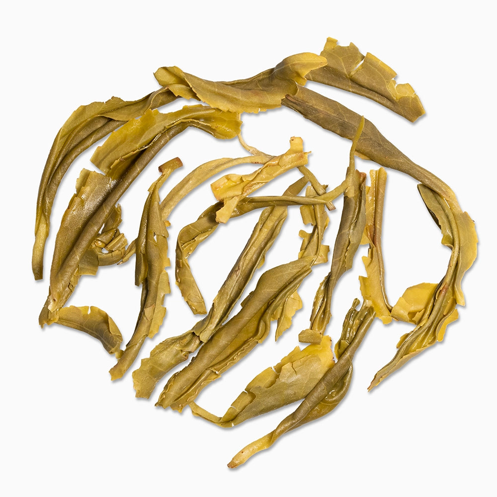 Steeped Pattumalay Emerald Twirl tea leaves — showcasing whole, unfurled leaves with vibrant olive tones and clean infusion integrity.